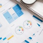 Sales Metrics - Magnifying Glass on White Paper